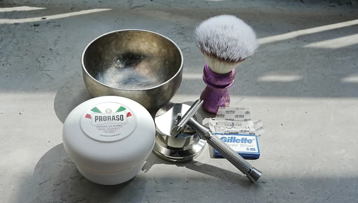 Gillette Silver Blue DE blade pack and the ORMIXA Vector 316L safety razor with a Proraso soap, titanium bowl and gradient brush on a neutral surface